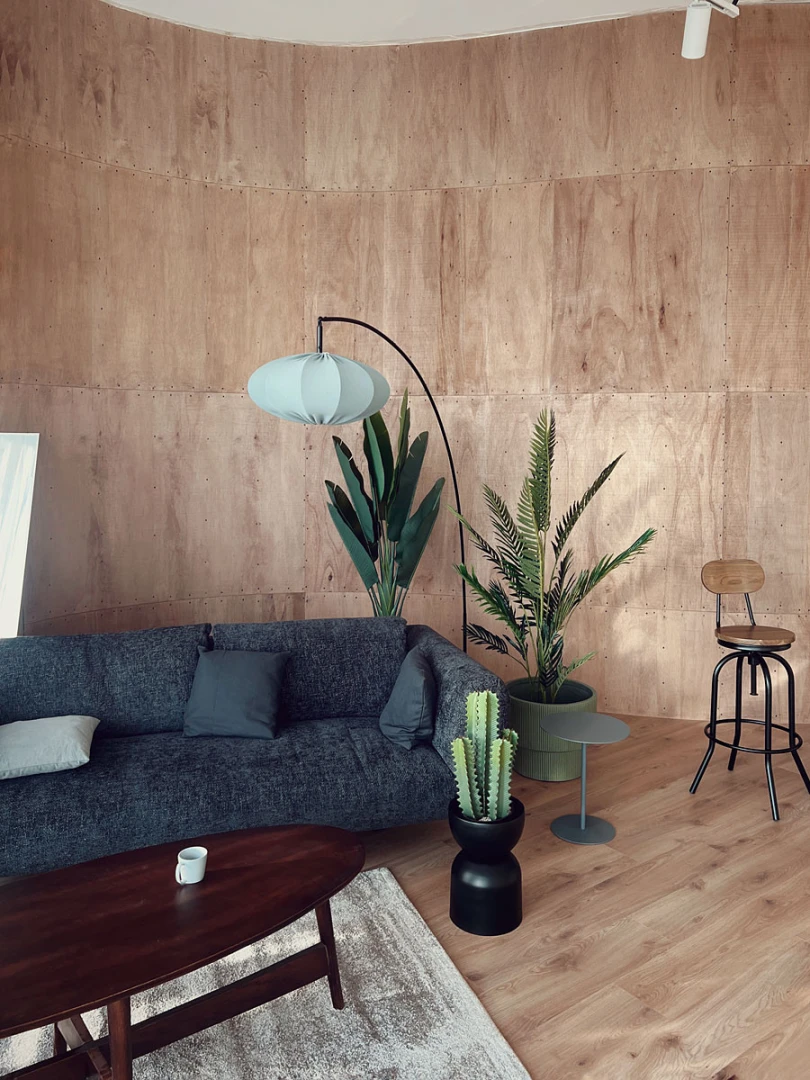 Modern lounge area in LUMA Studio, Dubai with plants and seating.