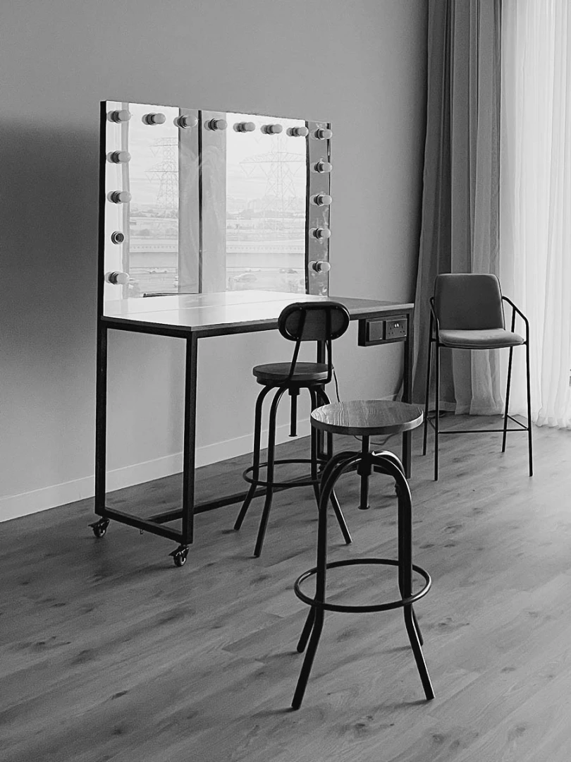 LUMA Studio Dubai, makeup station with chairs and mirror.