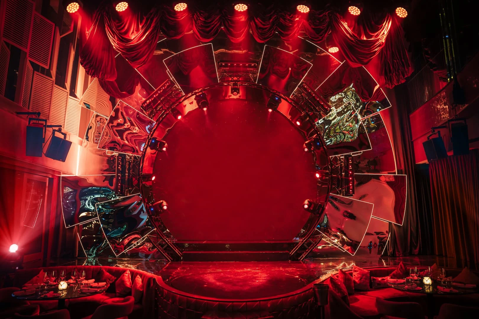 Red-lit stage with circular backdrop at Babylon Difc, Dubai.