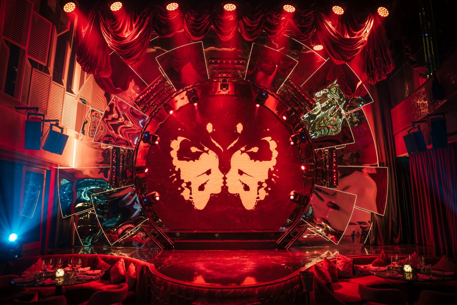 Babylon Difc Dubai stage with dramatic red lighting and decor.