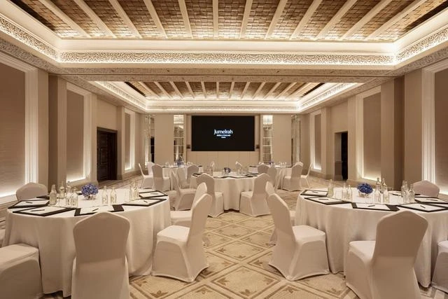Elegant banquet hall at Madinat Jumeirah, Dubai, with round tables.