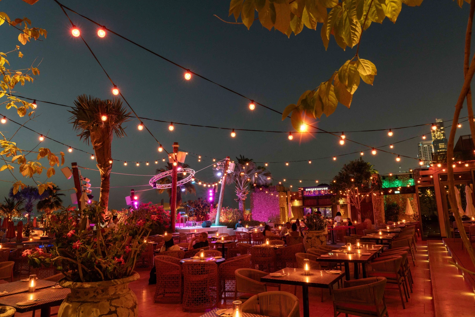 Bla Bla Dubai outdoor dining with string lights and palm trees.