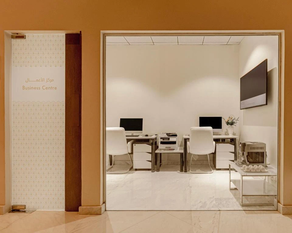 Khalidia Palace Hotel Dubai business center with computers and seating.
