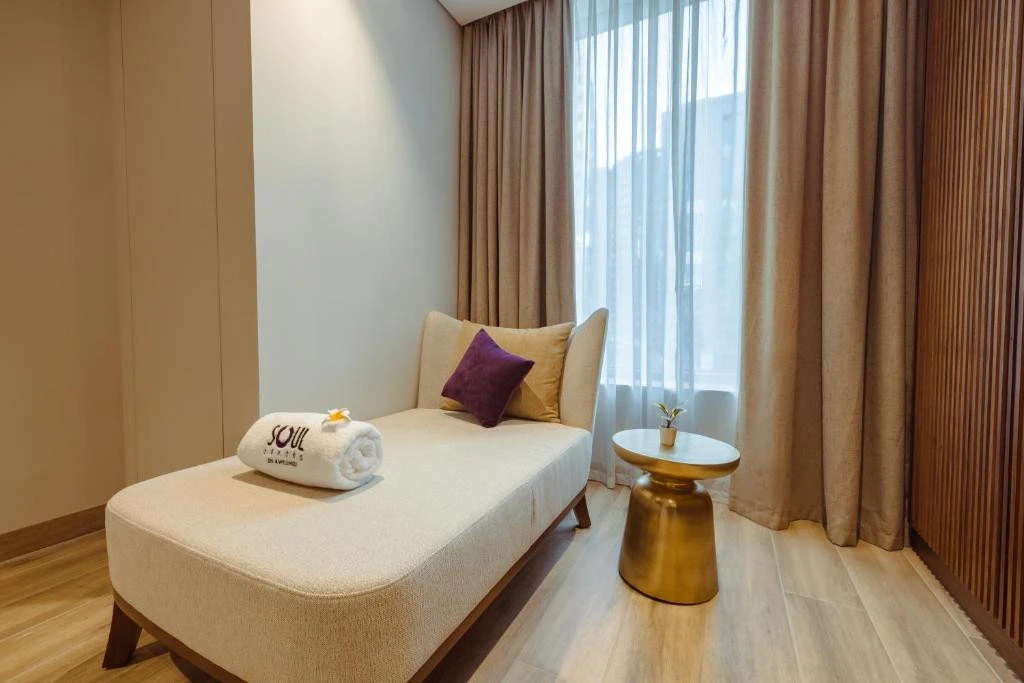 Elegant lounge area at Khalidia Palace Hotel Dubai with chaise lounge.