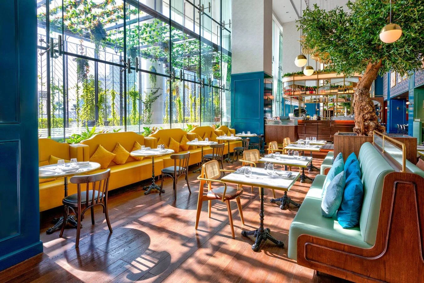Couqley French Brasserie Downtown Dubai, elegant dining area with greenery.