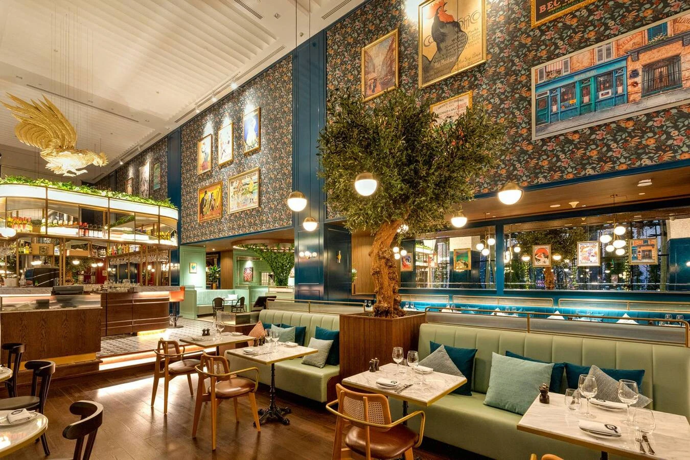 Chic Couqley Dubai dining room with tree and art-filled walls.