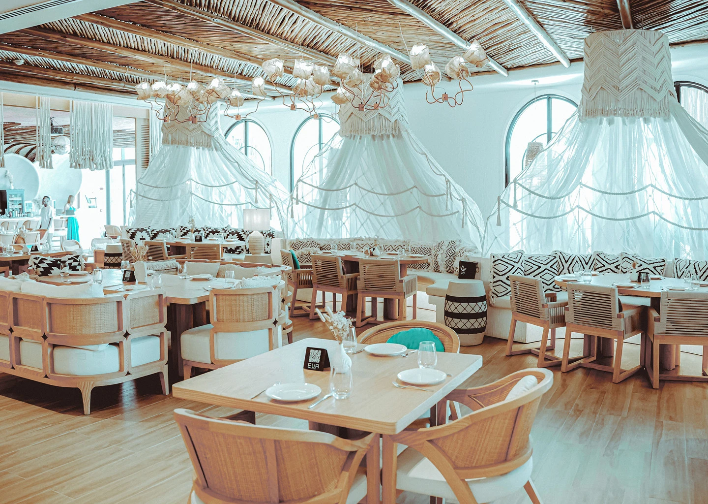 Elegant interior of EVA Beach Restaurant, Dubai with wooden decor.