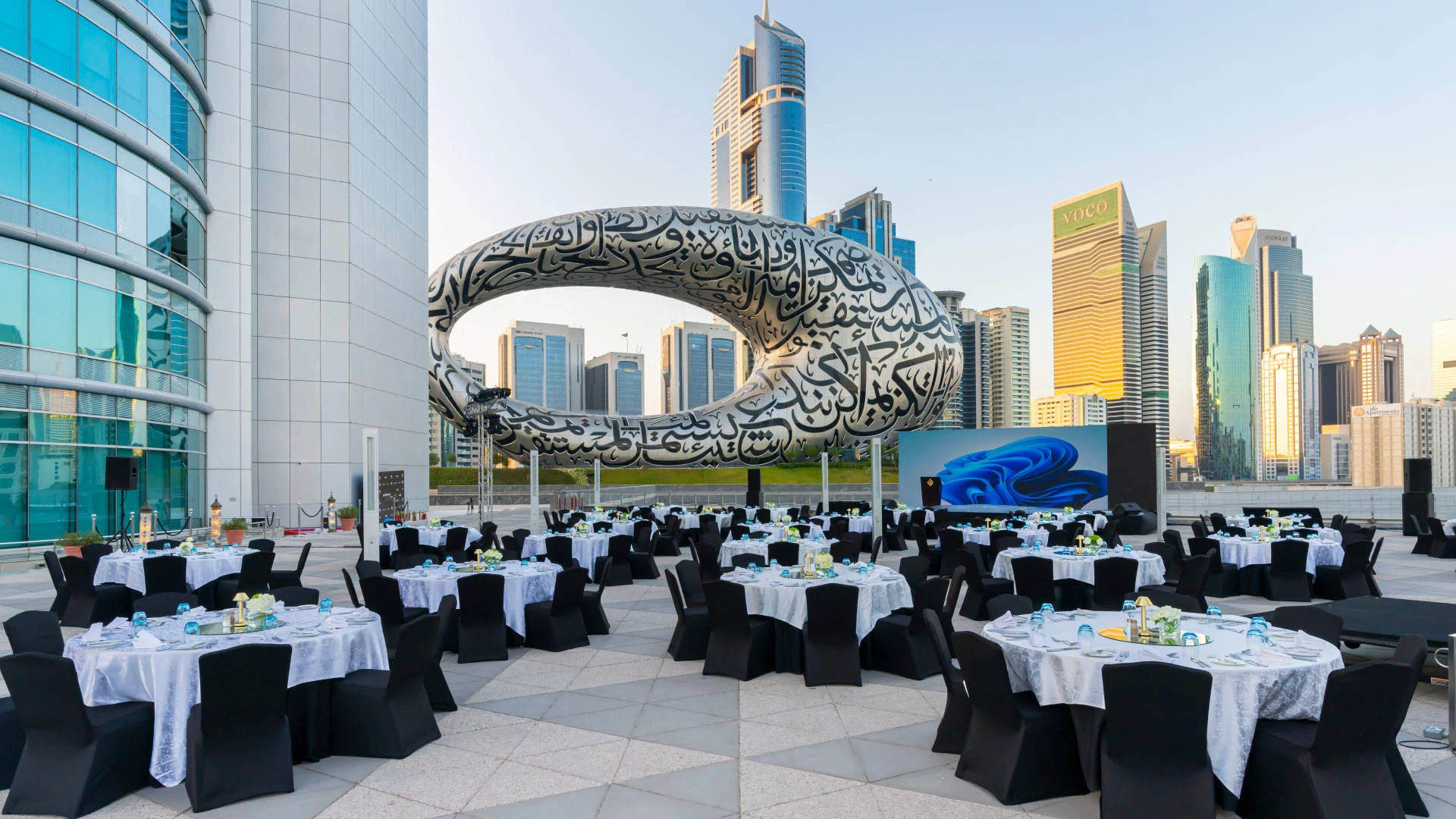 Outdoor event setup at Jumeirah Emirates Towers, Dubai with city skyline.