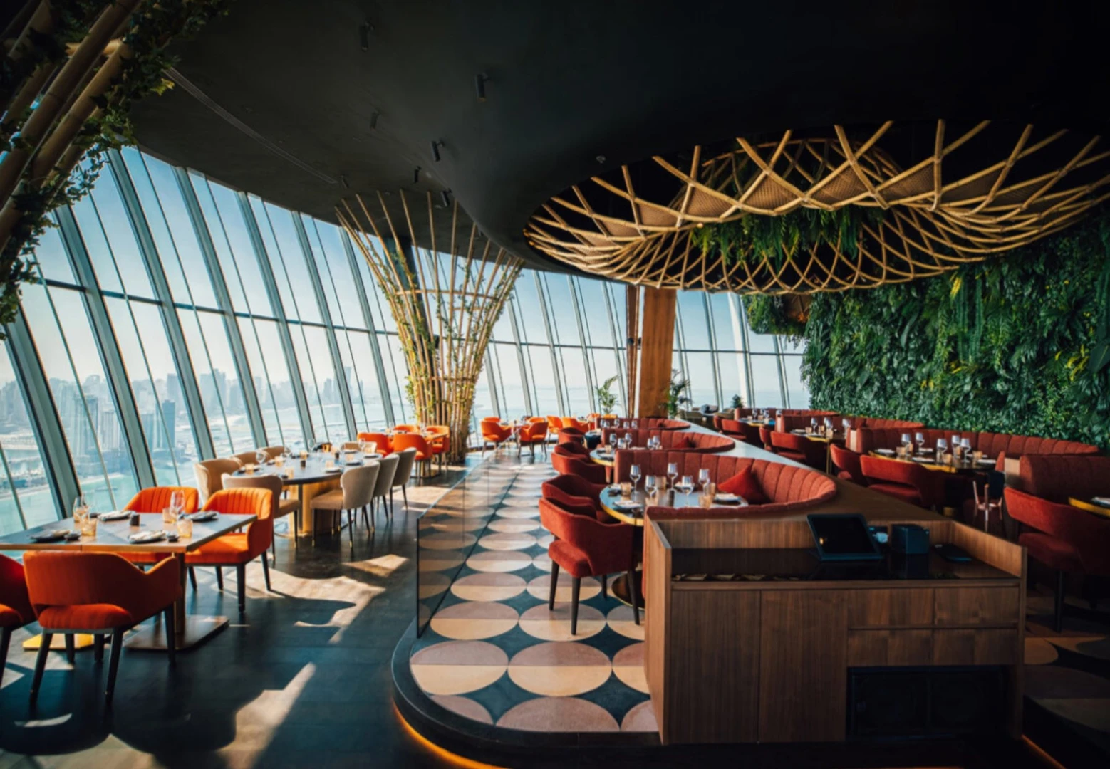 Sushisamba Dubai interior with panoramic city views and vibrant decor.