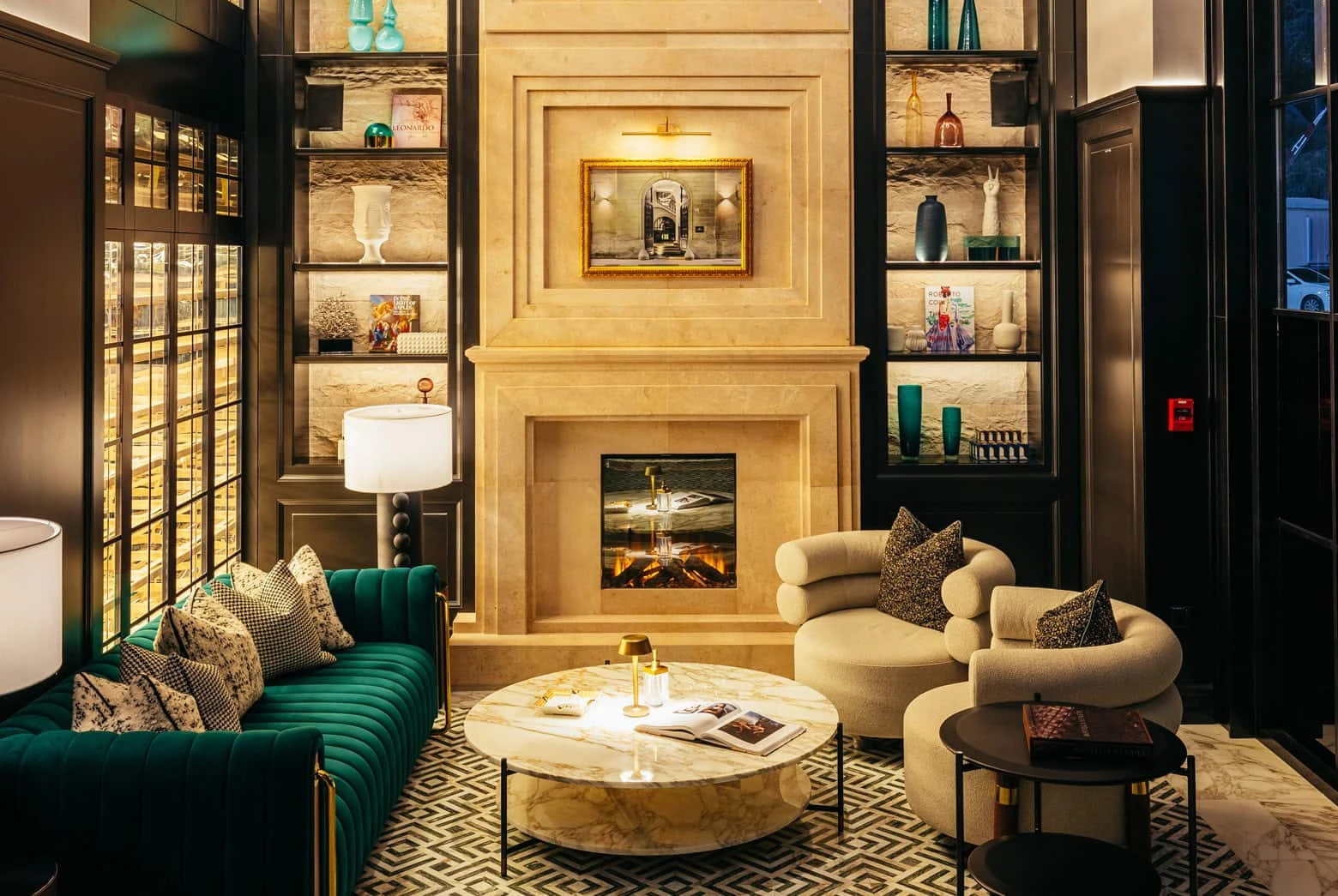 Elegant lounge area at Chic Nonna Dubai with fireplace and seating.