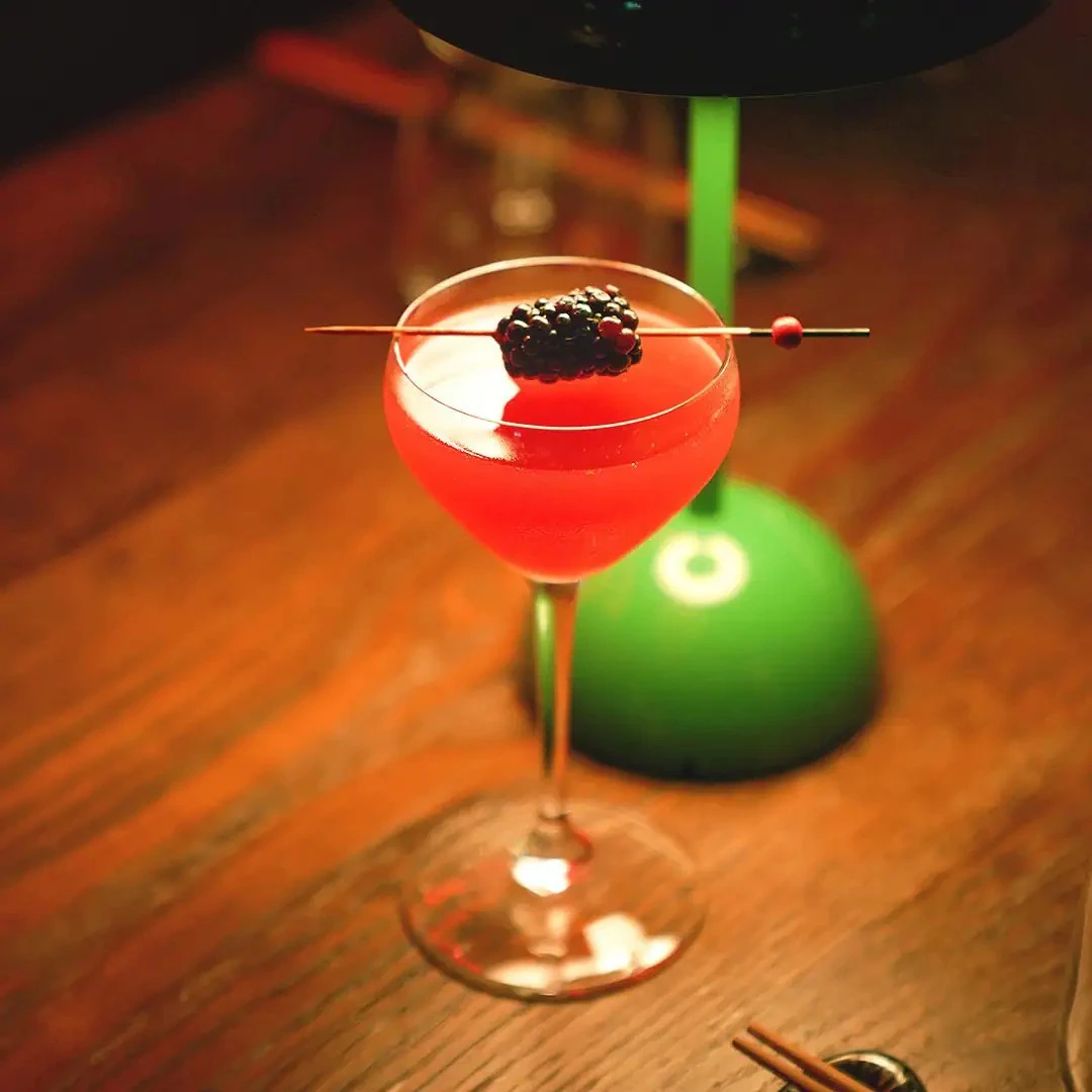 Cocktail with blackberry garnish at Hawkerboi, The Park JLT, Dubai.