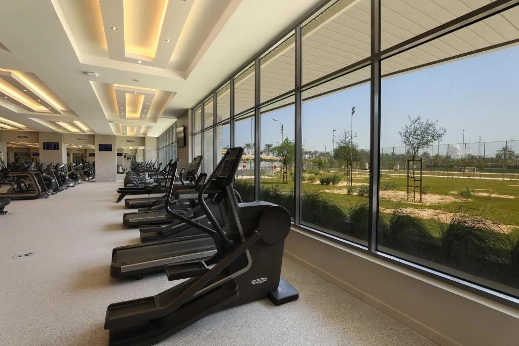 Modern gym with treadmills at Erth Hotel Abu Dhabi.