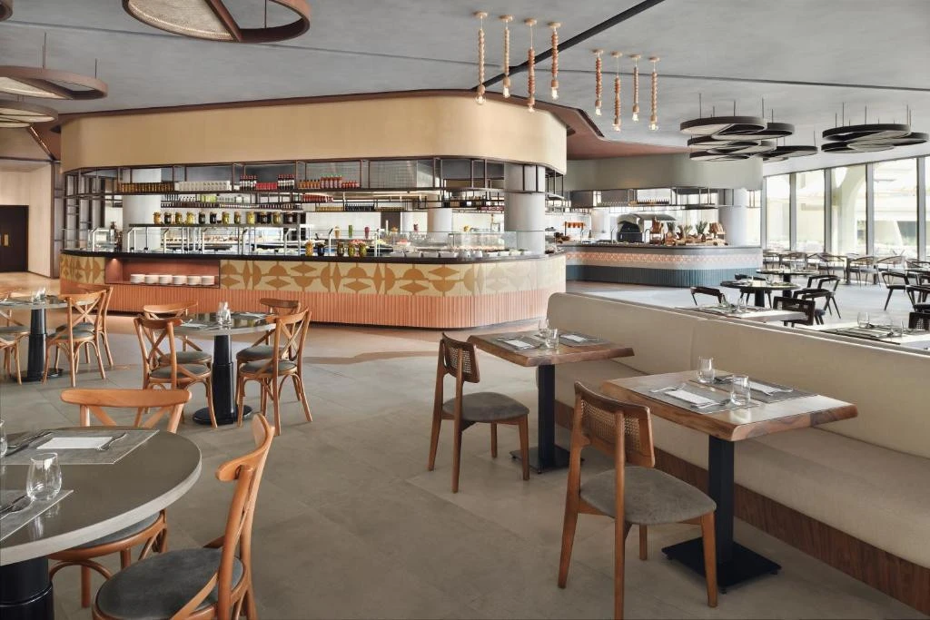 Modern restaurant interior at Erth Hotel Abu Dhabi, elegant seating arrangement.