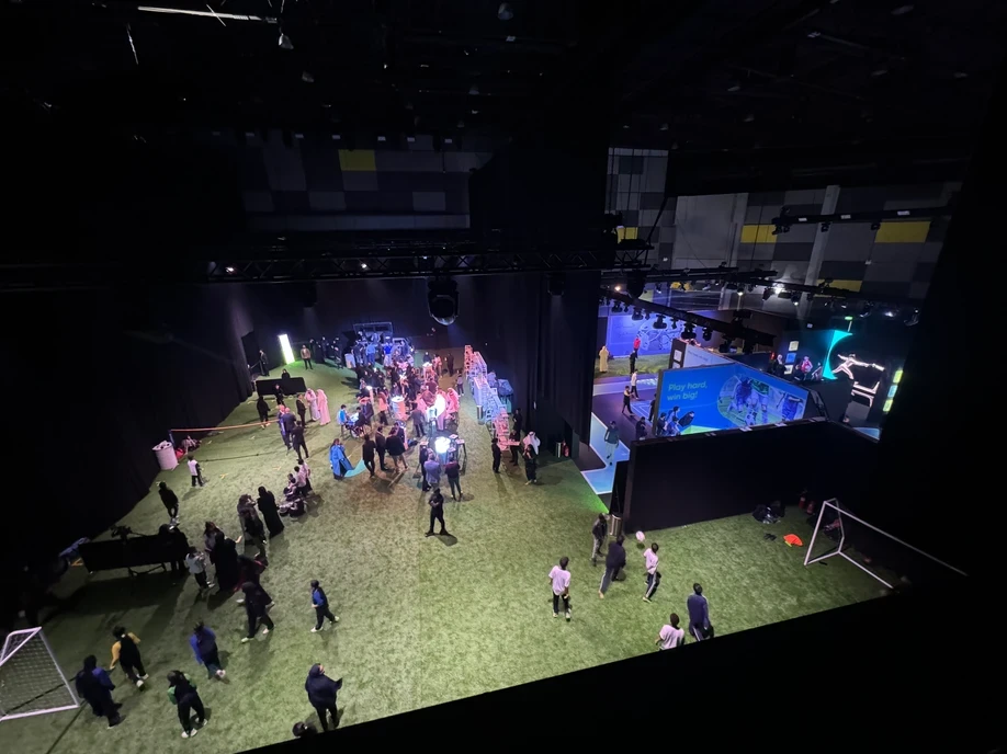 The Agenda Dubai indoor event with people on artificial turf.