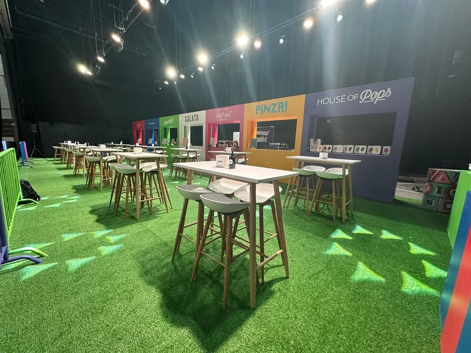 The Agenda Dubai venue with colorful food stalls and seating.