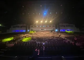 The Agenda venue in Dubai with seating and stage lighting.