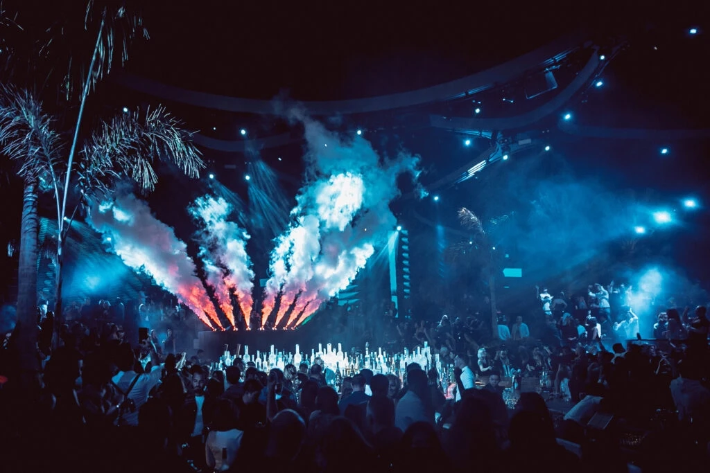 Sky2.0 Dubai nightclub with vibrant lights and smoke effects.