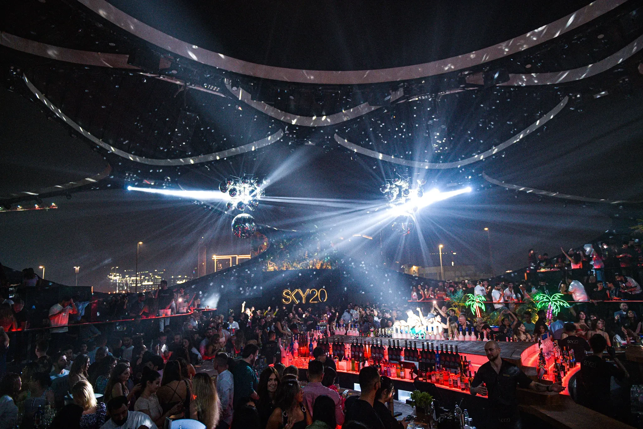 Crowded nightclub with lights and bar at Sky2.0 Dubai.