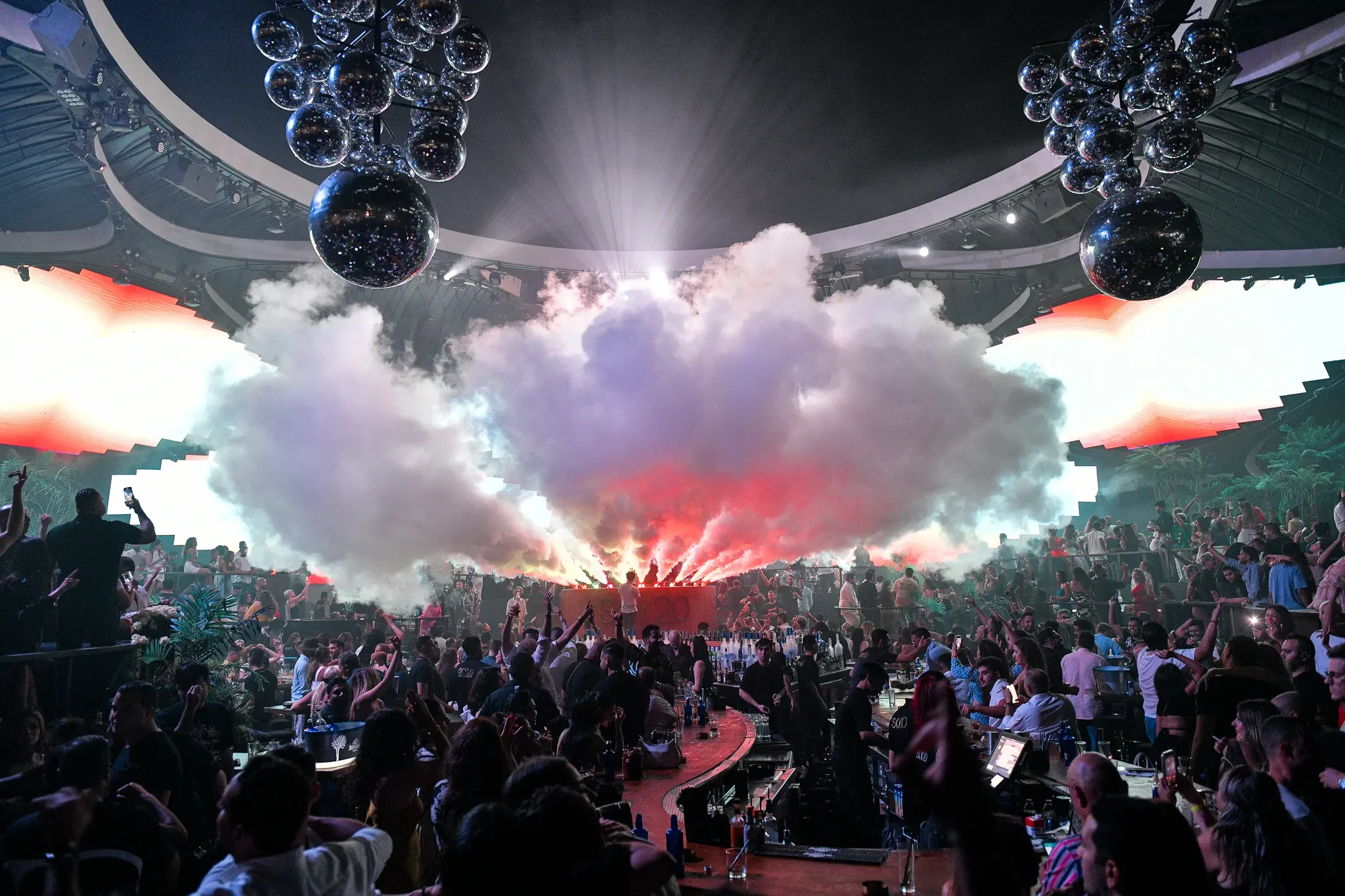Crowded nightclub with smoke and lights at Sky2.0 Dubai.