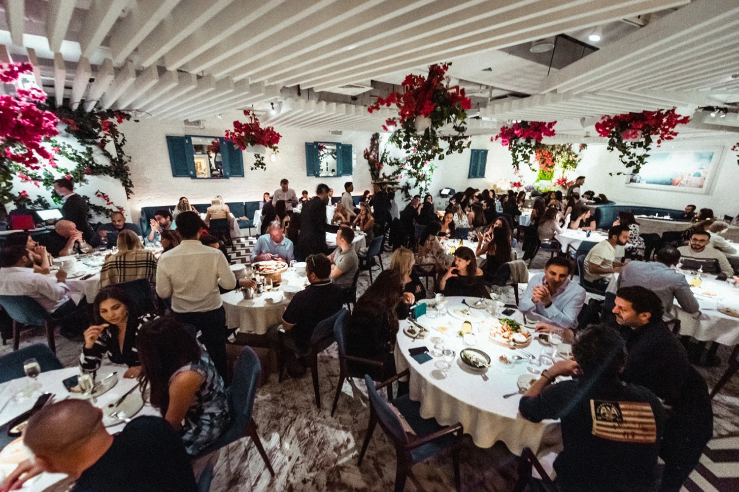 Crowded dining area at Opa Dubai with vibrant decor.