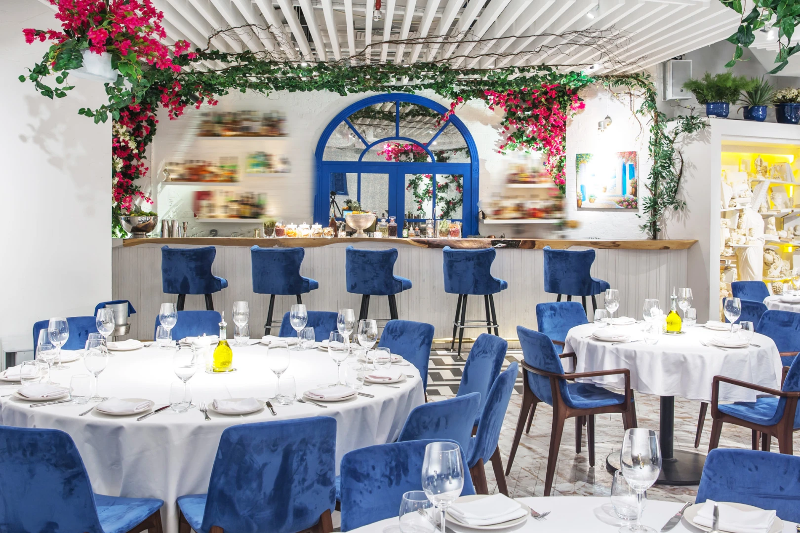 Elegant dining area with blue chairs at Opa Dubai restaurant.