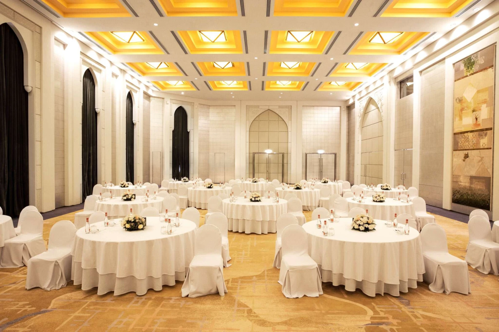 Elegant banquet hall at Shangri-La Dubai with round tables.