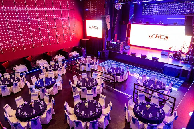 Elegant Boracay Night Club in Dubai with round tables and stage.