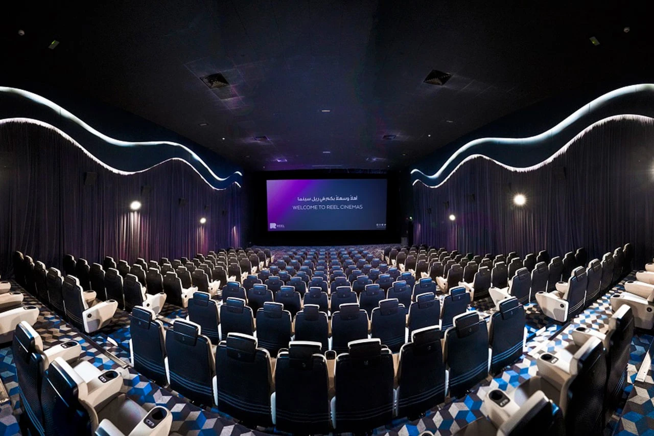 Spacious theater at Reel Cinemas, Dubai Marina Mall, with empty seats.