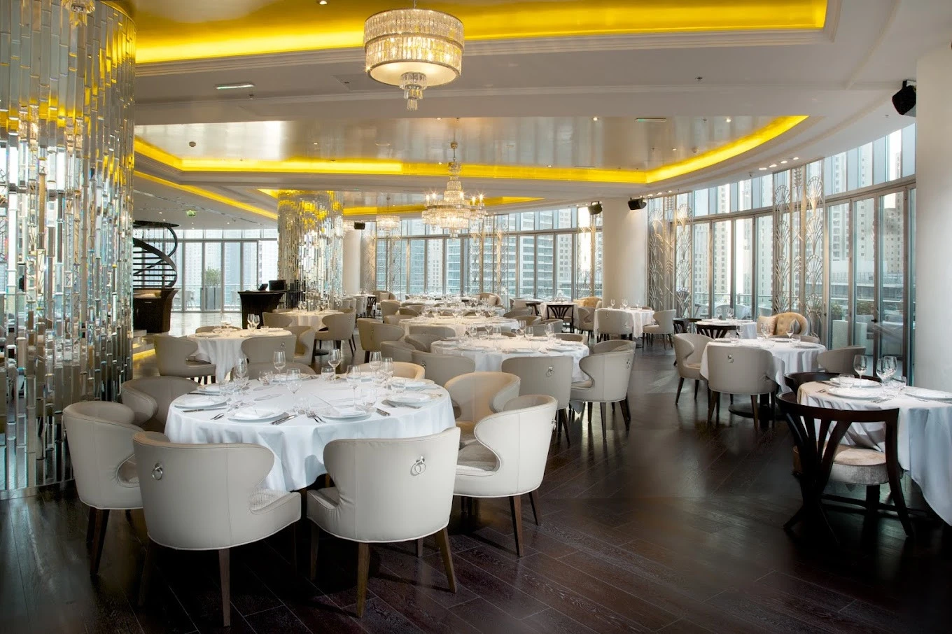 Luxurious dining space at Atelier M, Dubai with cityscape backdrop.