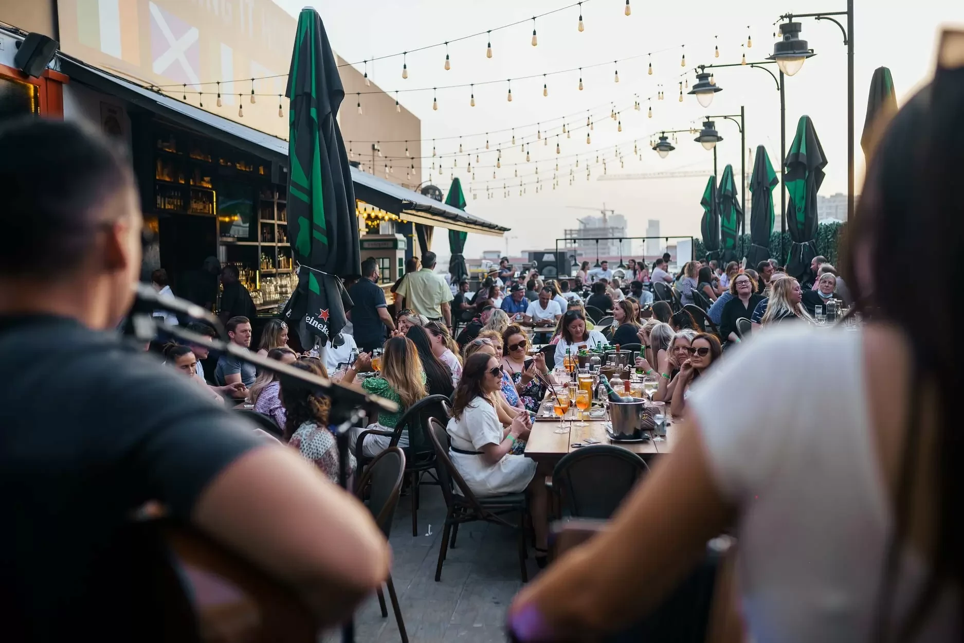 Crowded outdoor seating at McCafferty's Pub Jumeirah Village, Dubai.