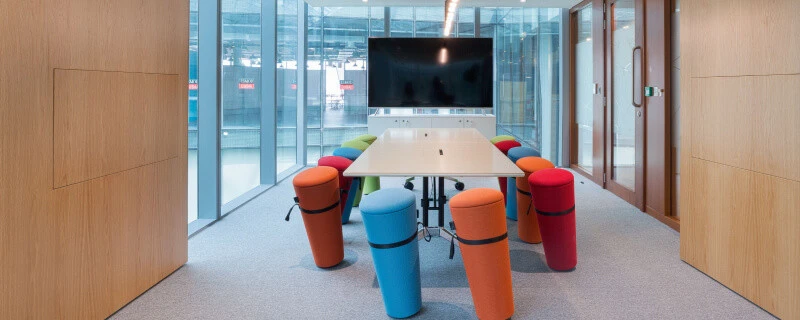 Colorful meeting room at D3 Dubai Design District with large screen.