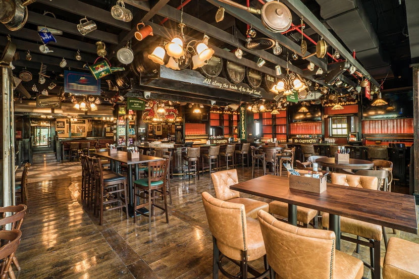 Cozy interior of McCafferty's Pub Jumeirah Village, Dubai, with wooden decor.