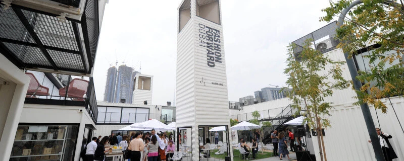 Outdoor event at D3 Dubai Design District with people and seating.