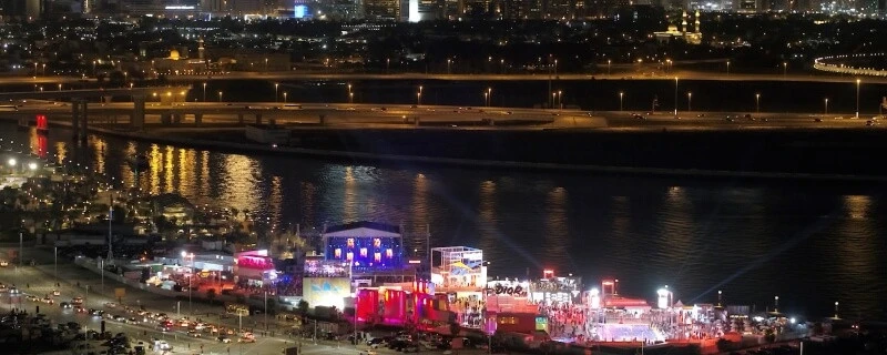 Night view of D3 Dubai Design District waterfront venue, illuminated buildings.