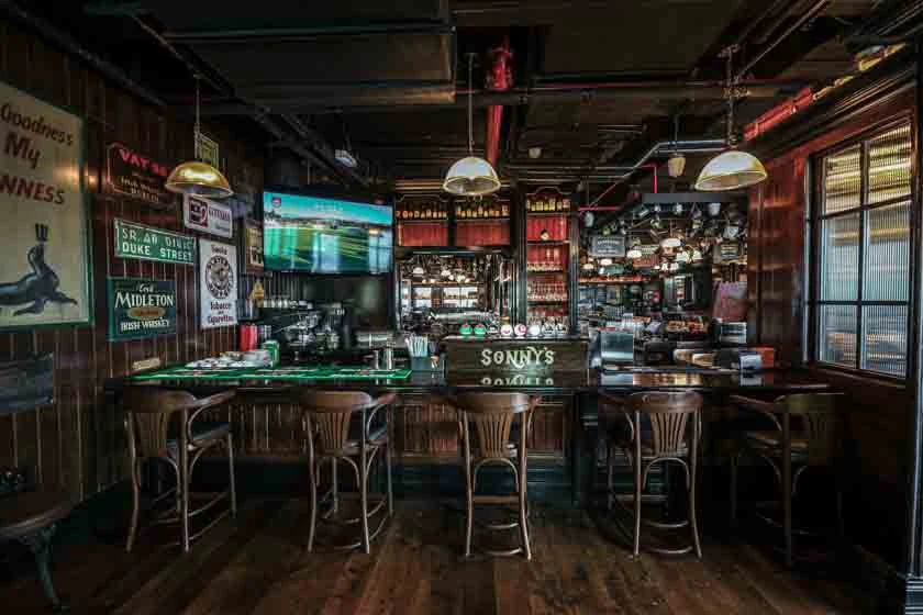 Cozy interior of McCafferty's Pub Jumeirah Village, Dubai with wooden decor.