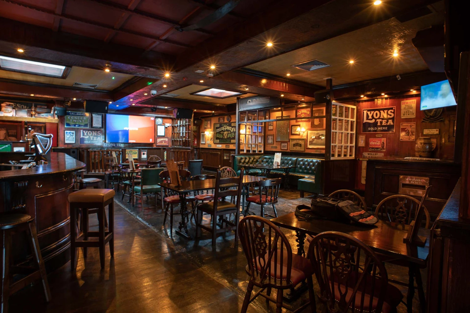 Rustic pub interior with vintage signs and wooden furnishings, Dubai.