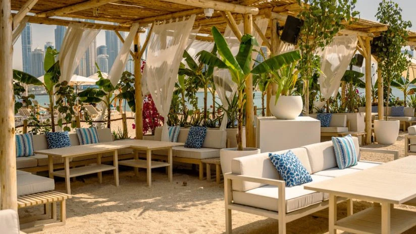 Outdoor seating at Surf Club Dubai with city skyline view.