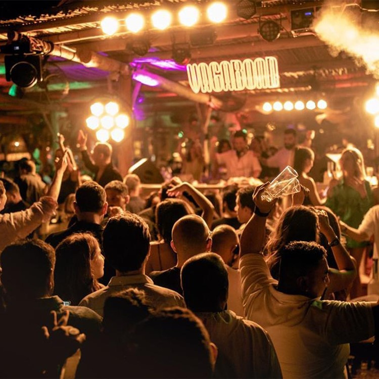 Crowded party at Surf Club Dubai with vibrant lighting.