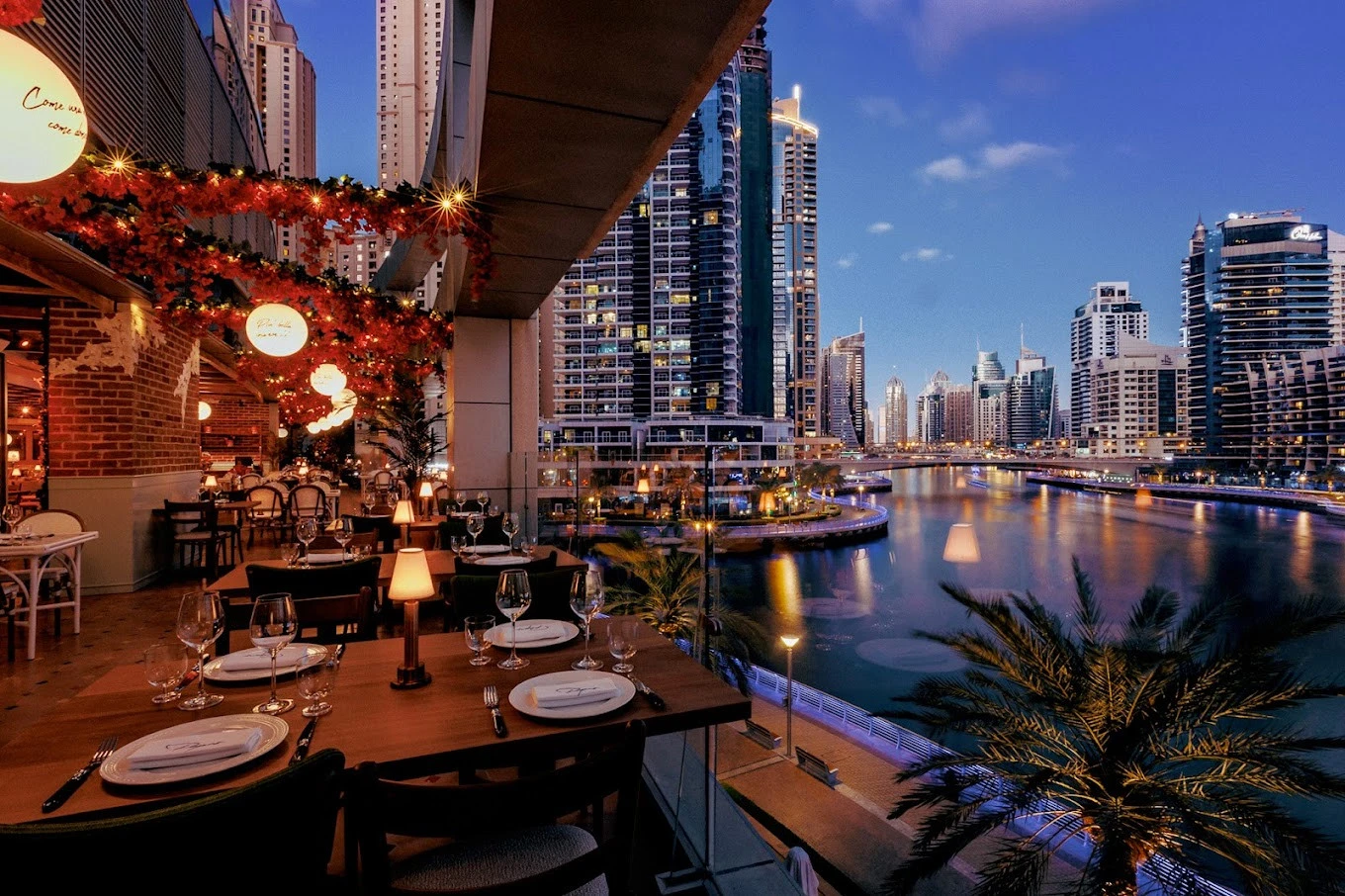 Papas Dubai Marina terrace overlooking city skyline and waterfront at dusk.