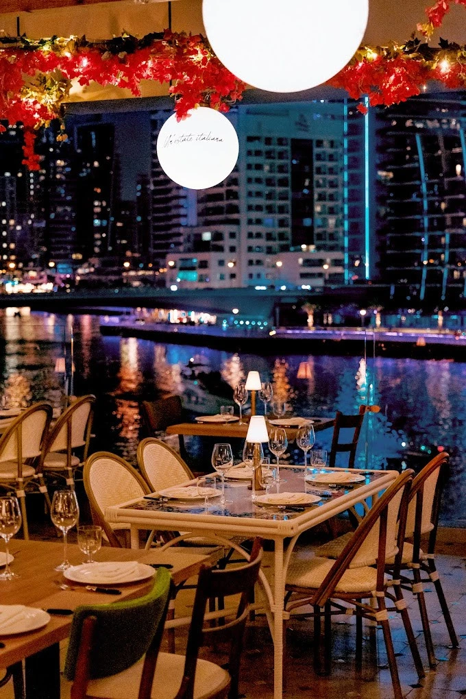 Elegant dining setup at Papas Dubai Marina overlooking waterfront.