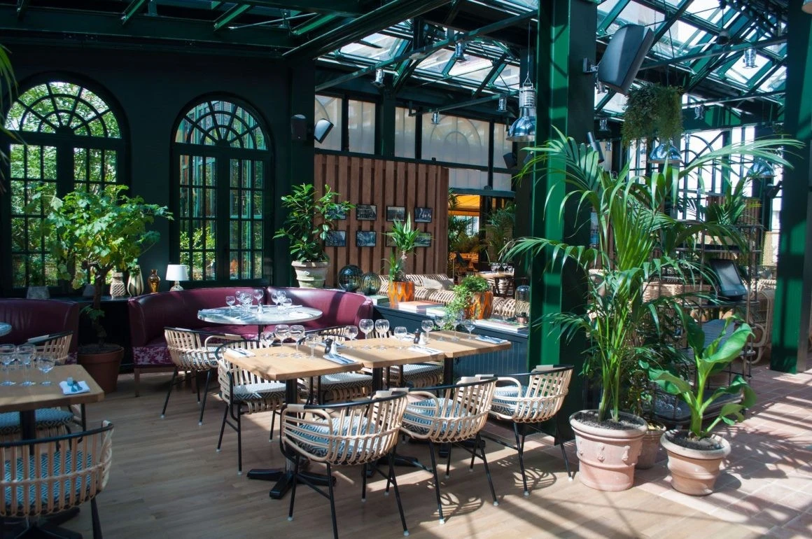 Eugène Eugène Restaurant Dubai, elegant interior with lush greenery.