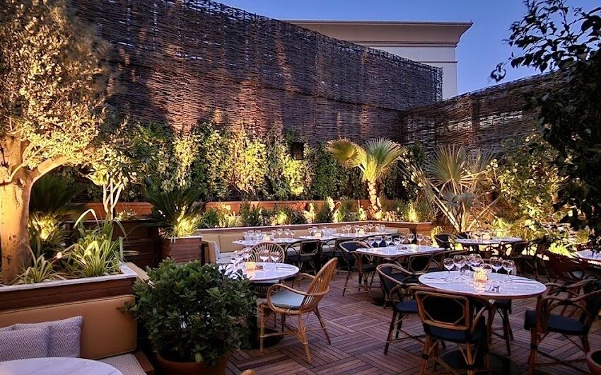 Eugène Eugène Restaurant Dubai outdoor dining area with lush greenery.