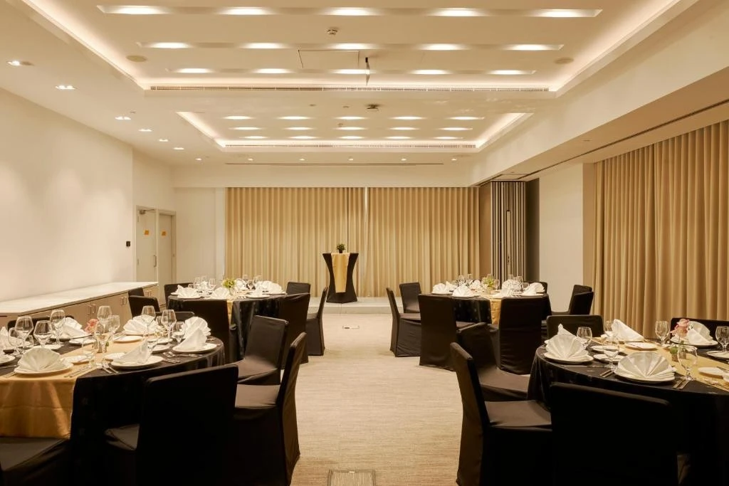 Sophisticated banquet room with round tables at Citymax Hotel, Dubai.