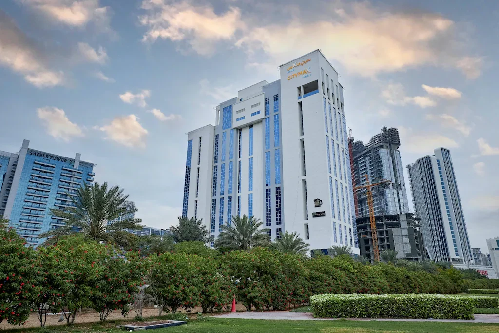 Citymax Hotel Business Bay skyscraper in Dubai with cloudy sky.