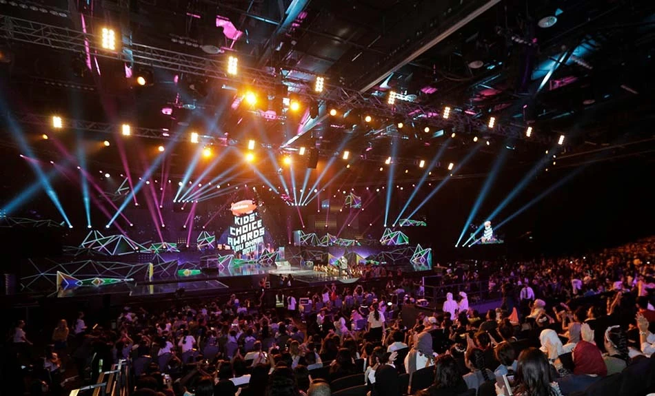 ADNEC Centre Abu Dhabi event with colorful stage lights and audience.