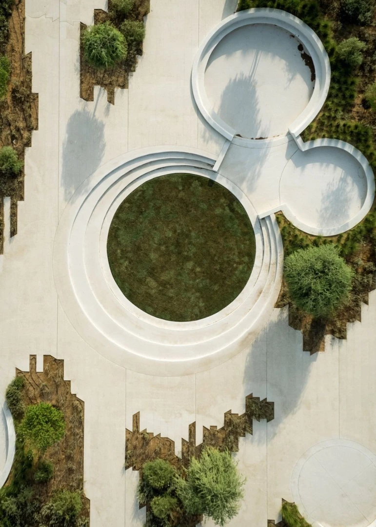 Aerial view of Erth Hotel Abu Dhabi's modern circular landscape design.