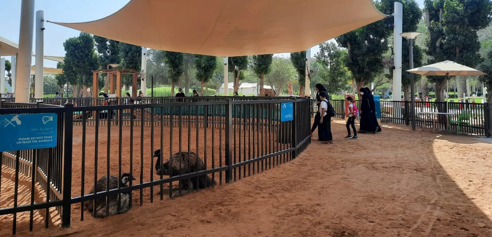 Animal enclosure at Umm Al Emarat Park, Abu Dhabi with visitors.