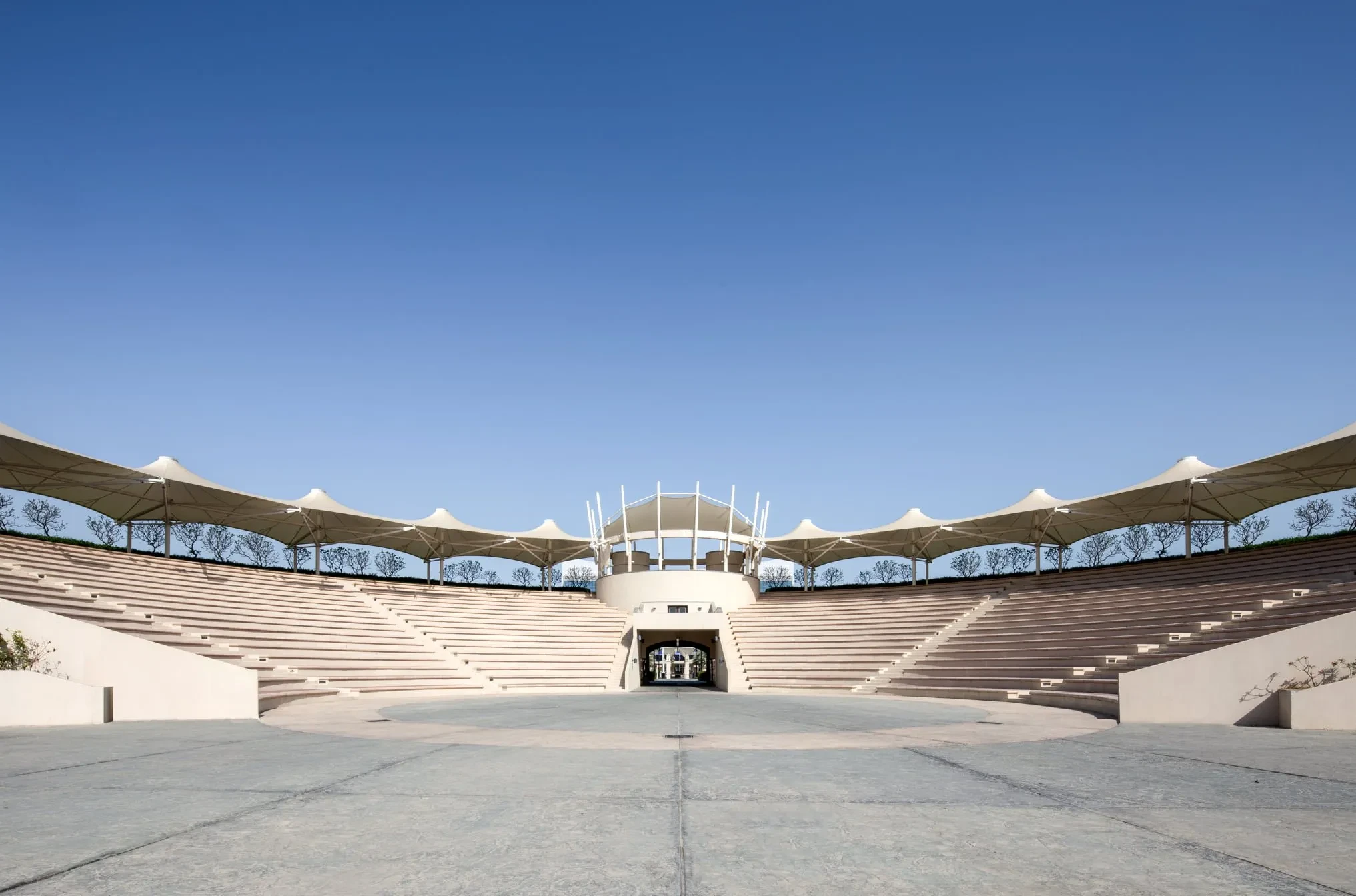 Khalifa Park Amphitheater in Abu Dhabi, open-air seating under canopies.