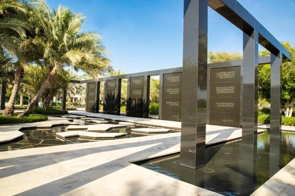Modern black stone structure with palm trees, Umm Al Emarat Park, Abu Dhabi.