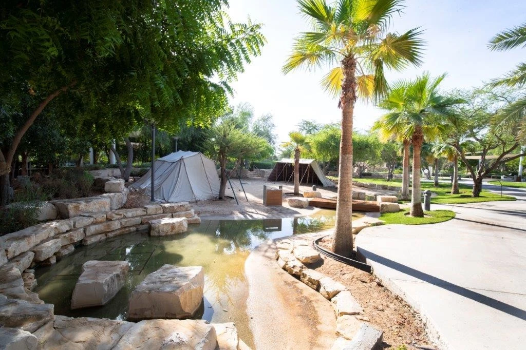 Umm Al Emarat Park with tents and palm trees, Abu Dhabi.